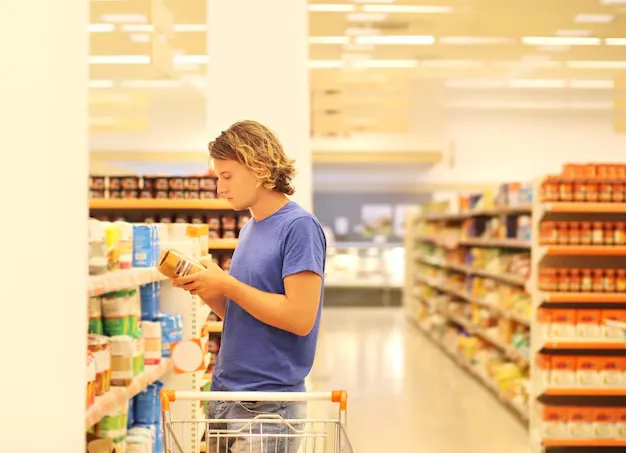 Person reading product information while shopping mindfully